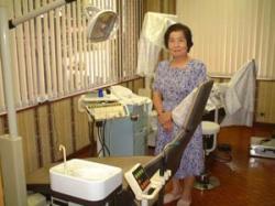 Mrs.Tezuka with the dental clinic she donated