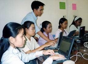 Computer training with the president of the Khmer Development Community