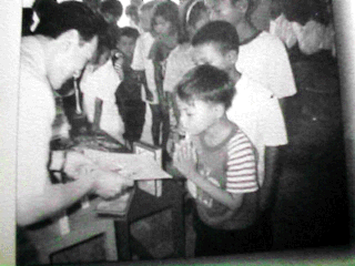 Photo: Distributing stationary supplies to children in Cambodia.